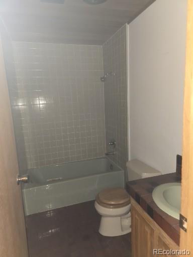 131 Hitchrack Road Bailey, CO 80421 - Photo 12 of 22 a bathroom with a granite countertop toilet and a sink