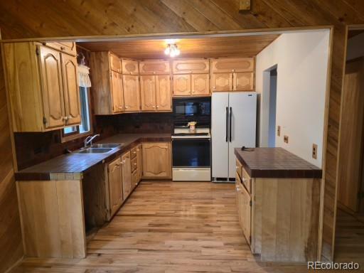 131 Hitchrack Road Bailey, CO 80421 - Photo 7 of 22 a kitchen with stainless steel appliances granite countertop a refrigerator a sink dishwasher a stove and a microwave oven with wooden floor
