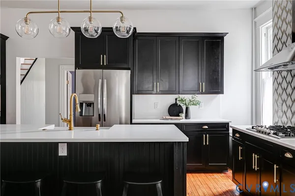 a kitchen with a table chairs stove and cabinets