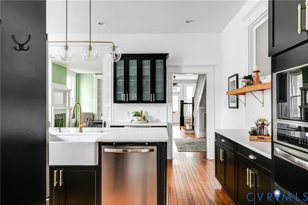 a kitchen with stainless steel appliances a sink stove and refrigerator