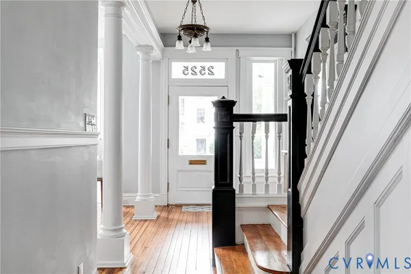 a bed sitting in a bedroom next to a window and a fireplace