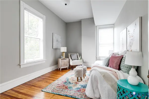 a bedroom with a bed and wooden floor
