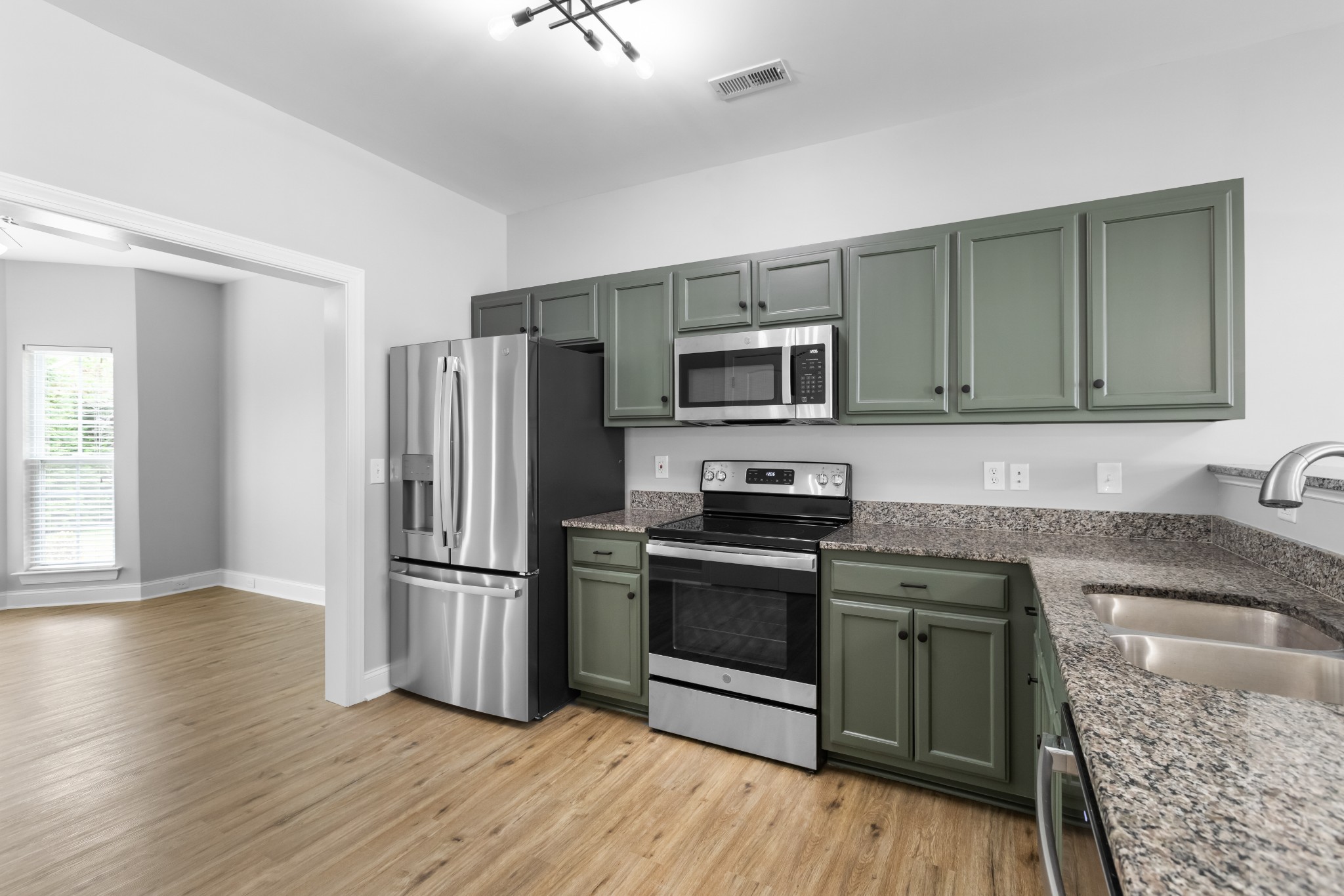 216 Rowlette Circle Murfreesboro, TN 37127 - Photo 16 of 36 a kitchen with granite countertop a refrigerator stove and microwave