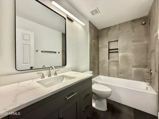 a bathroom with a sink a toilet and a bathtub