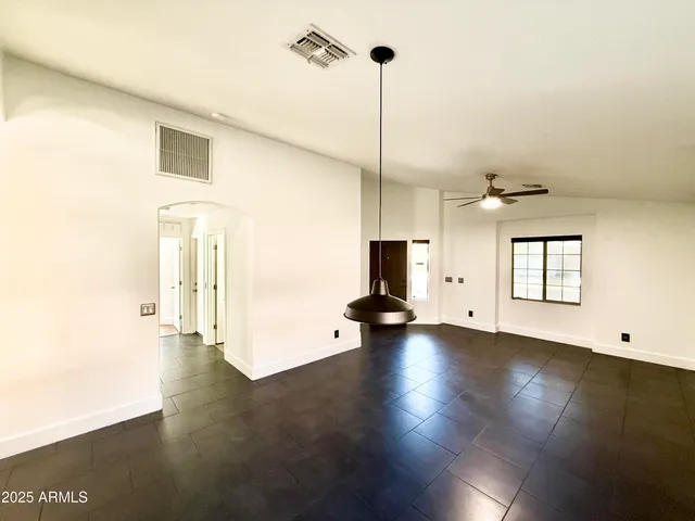 a view of empty room with wooden floor and fireplace