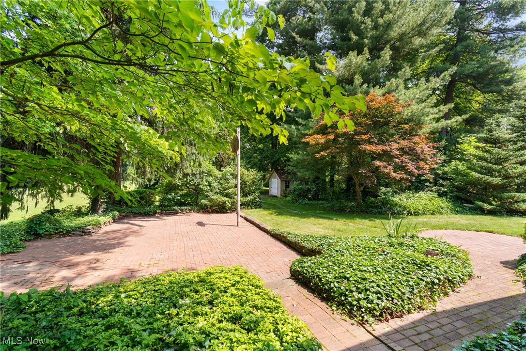 2321 Killian Road Akron, OH 44312 - Photo 28 of 36 Outside, the basketball hoop can help burn off a few calories. The brick patio is surrounded by stacked stones creating flower beds.