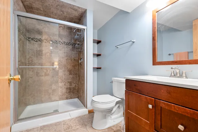 a bathroom with a shower a toilet and a sink