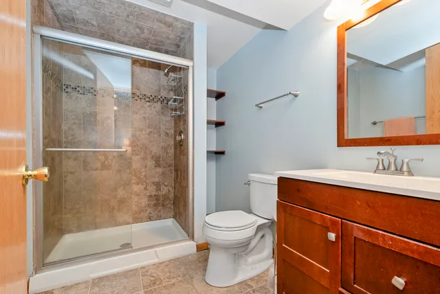 a bathroom with a sink a toilet and shower