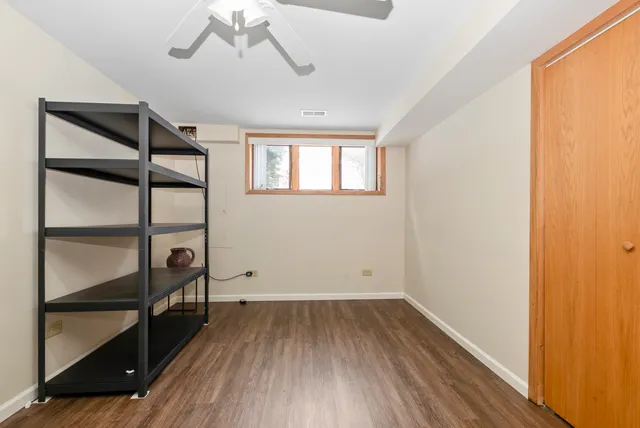 a view of a room with wooden floor and windows