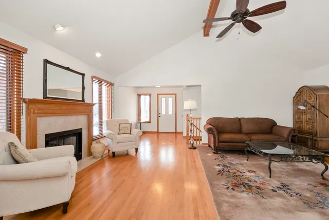 a living room with furniture fireplace and window