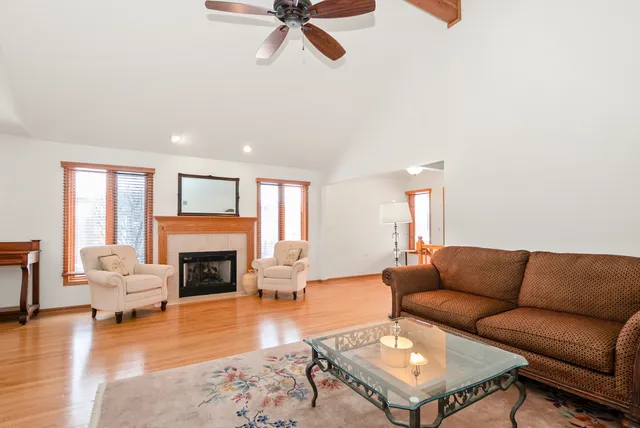 a living room with furniture fireplace and a table