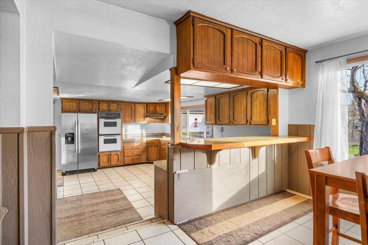 1360 Oxyoke Road Grants Pass, OR 97526 - Photo 13 of 39 a view of a kitchen with furniture and a window