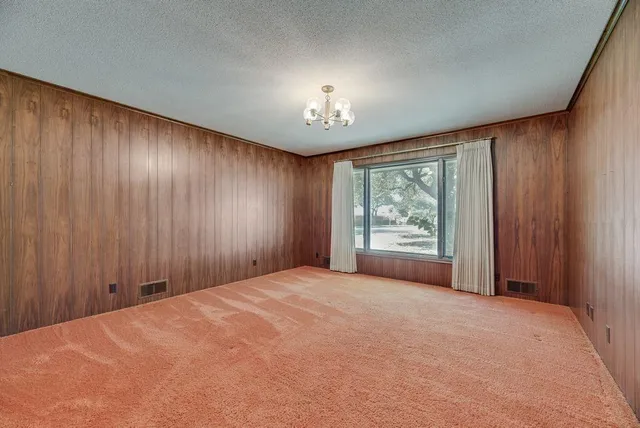 an empty room with a wooden door