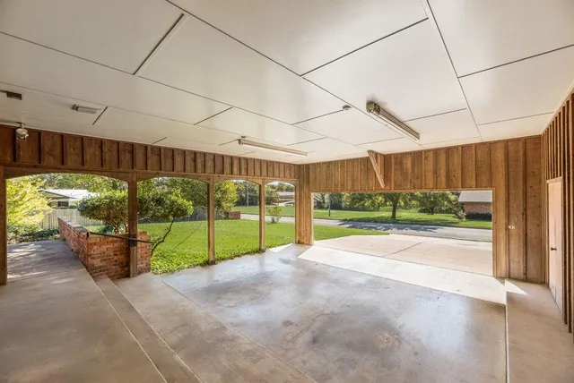 a front view of a house with yard and green space