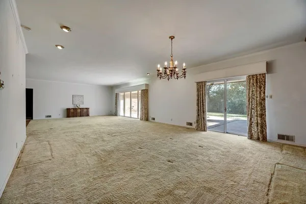 a big room with windows and a chandelier