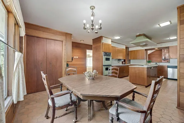 a view of a dining room with furniture and chandelier