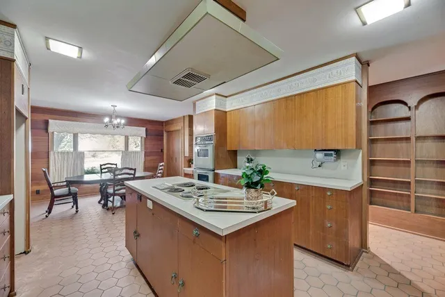 a kitchen with a stove and a refrigerator