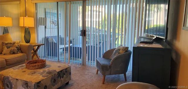 a bedroom with a bed and teddy bear on bed