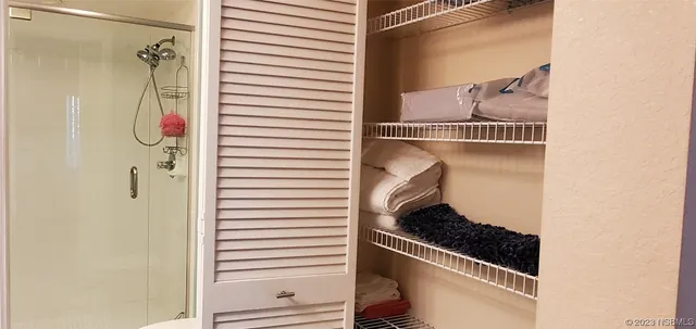 a balcony with furniture and a potted plant