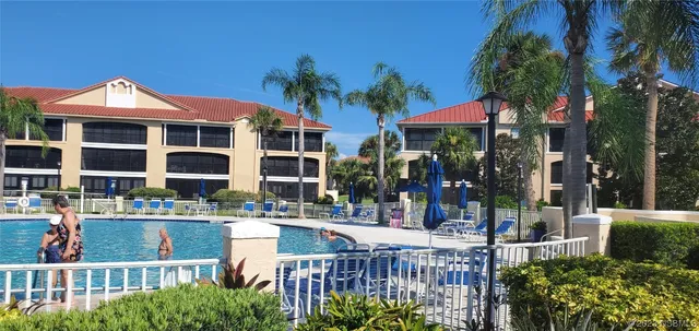 a view of a building with a garden and pathway