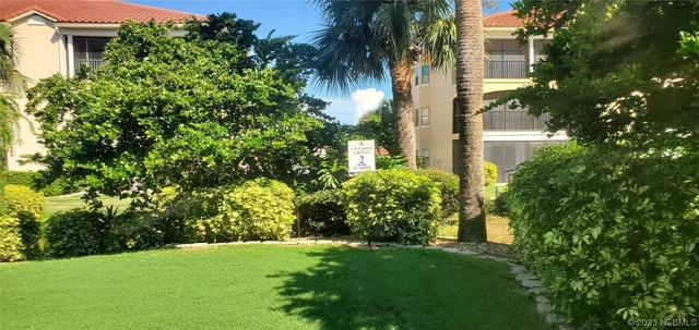 a view of a cars park in front of a building