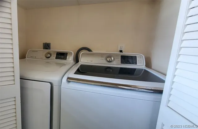 a bedroom with a bed and large windows
