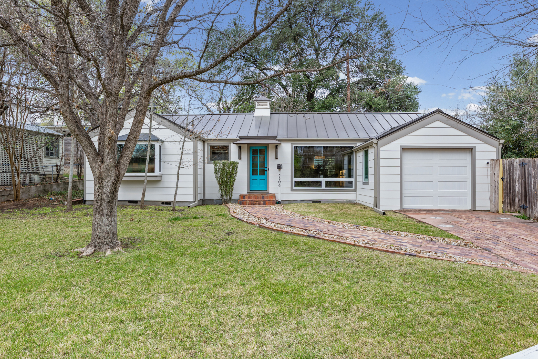 3906 Jefferson Street Austin, TX 78731 - Photo 1 of 1 a view of a house with a backyard and a tree