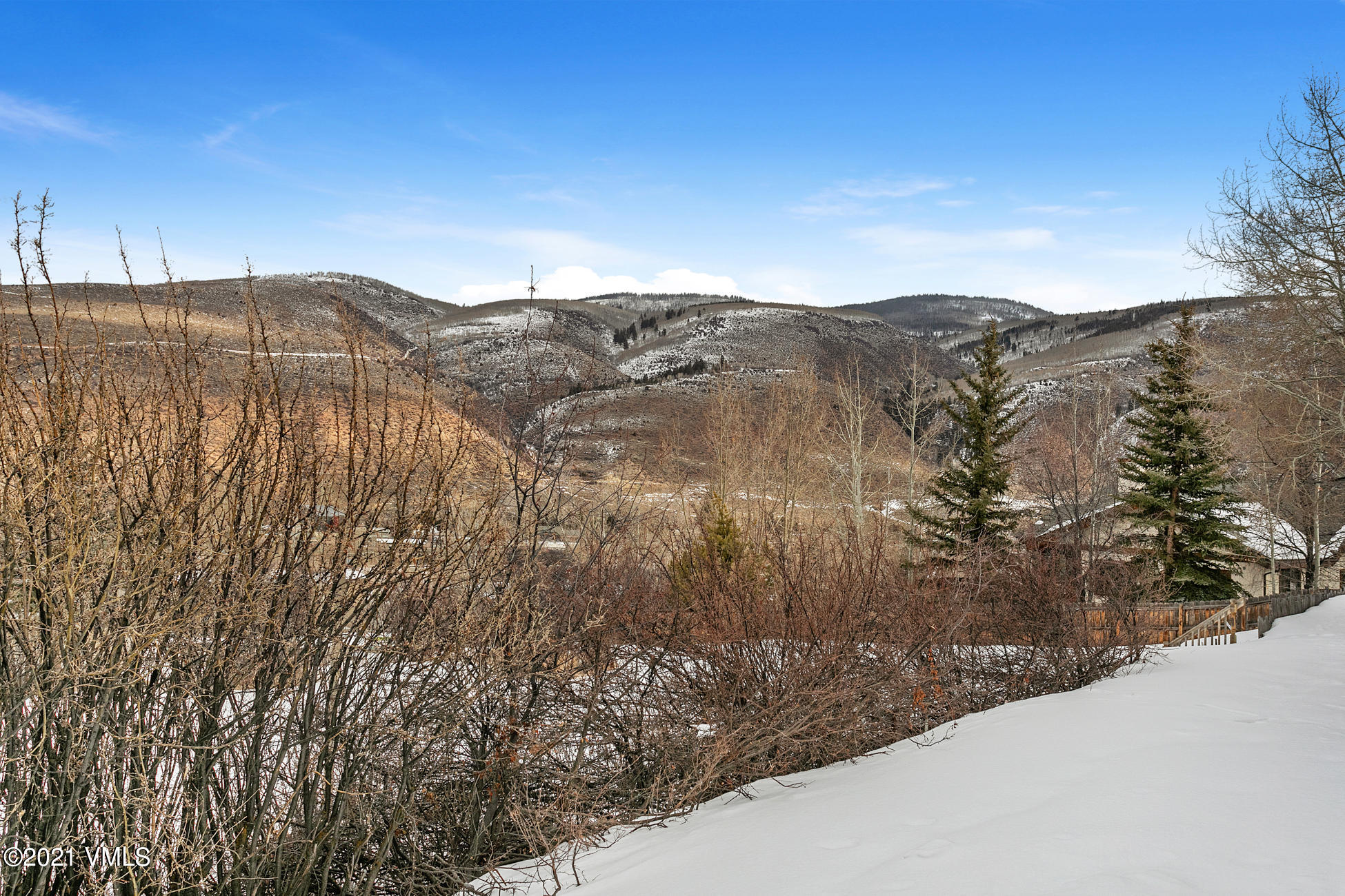 596 Daisy Lane, Unit 5 Avon, CO 81620 - Photo 17 of 23 a view of a dry yard with mountains in the background