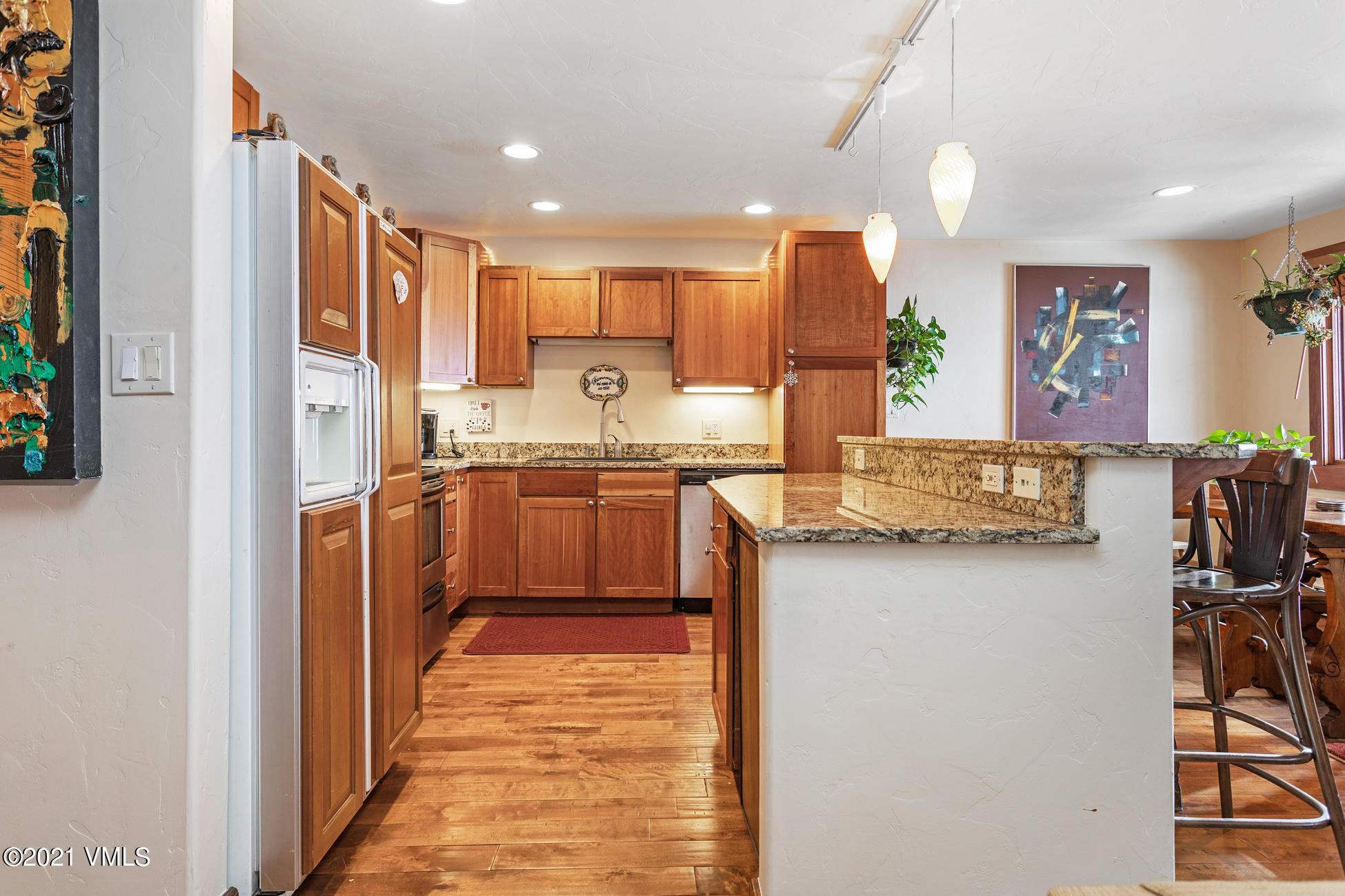 596 Daisy Lane, Unit 5 Avon, CO 81620 - Photo 2 of 23 a kitchen with stainless steel appliances granite countertop a sink and cabinets