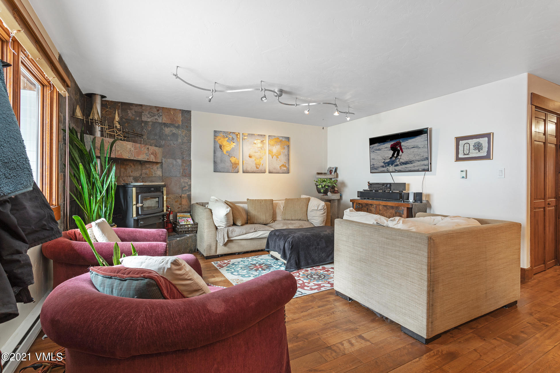 596 Daisy Lane, Unit 5 Avon, CO 81620 - Photo 6 of 23 a living room with furniture and a flat screen tv