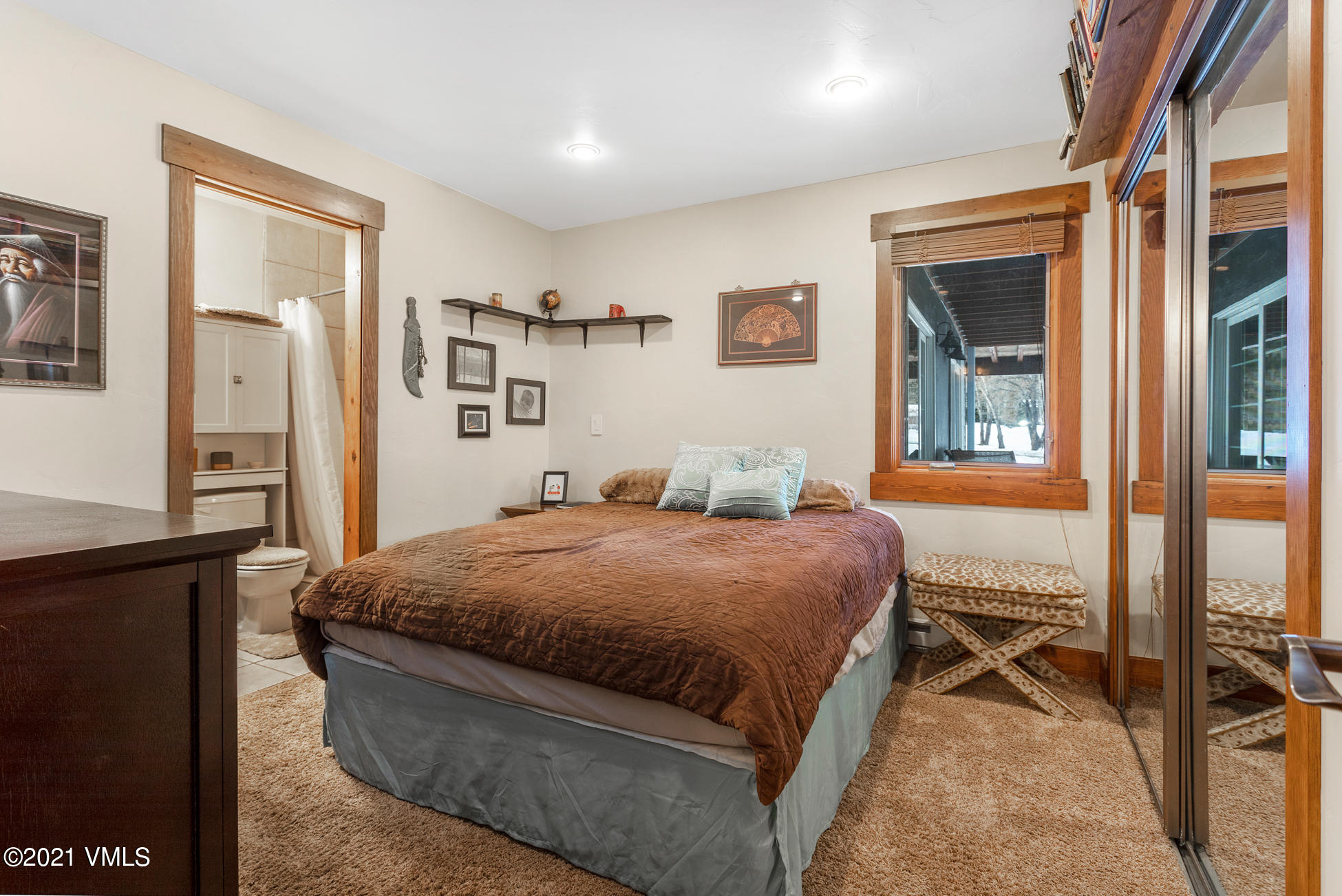 596 Daisy Lane, Unit 5 Avon, CO 81620 - Photo 9 of 23 a bedroom with a bed and glass door