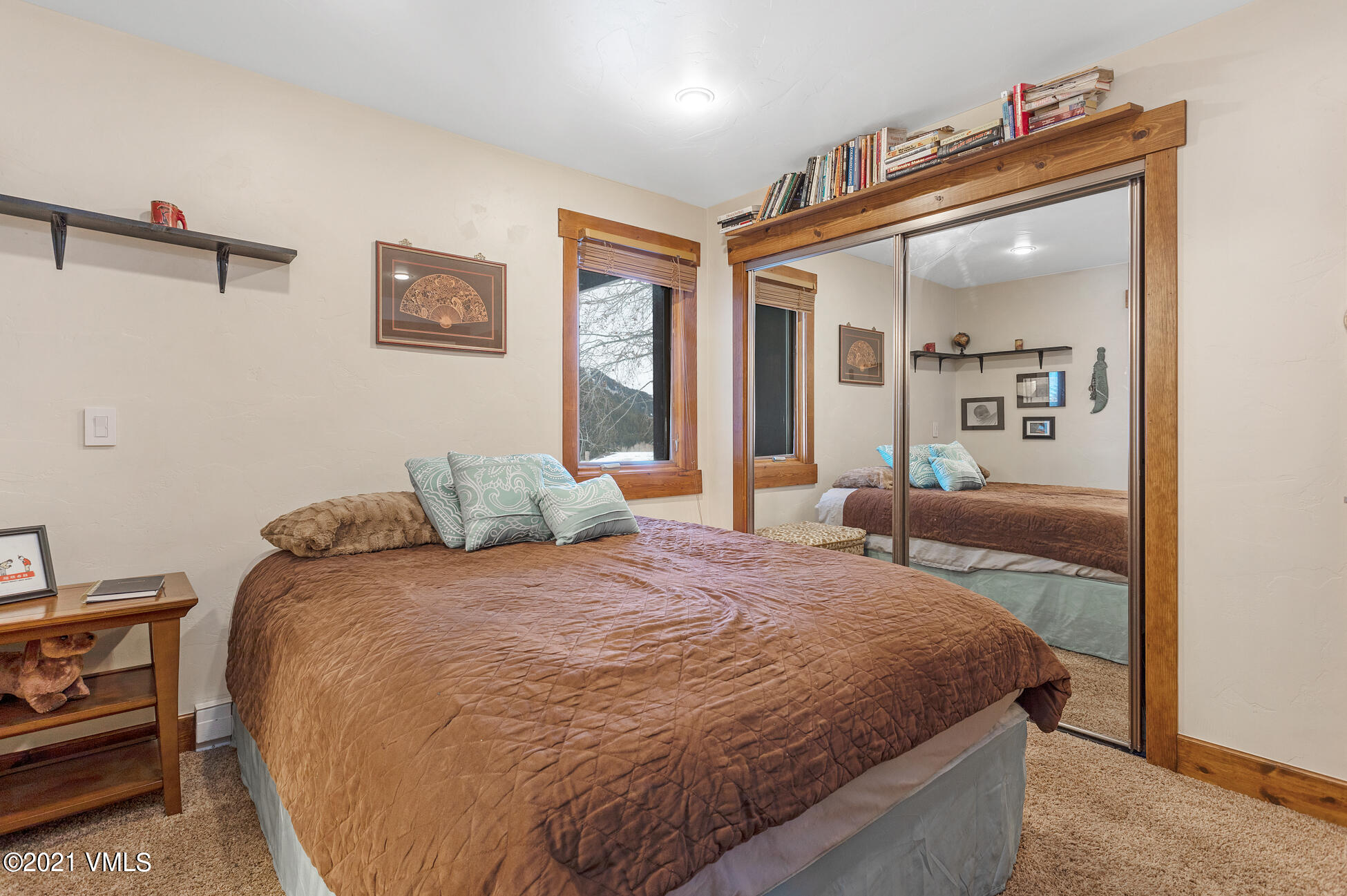 596 Daisy Lane, Unit 5 Avon, CO 81620 - Photo 10 of 23 a bedroom with a large bed and a chandelier