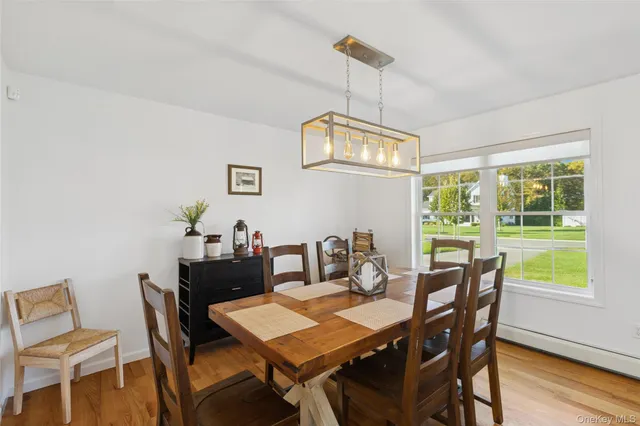 a view of a dining room with a table chairs and chandelier