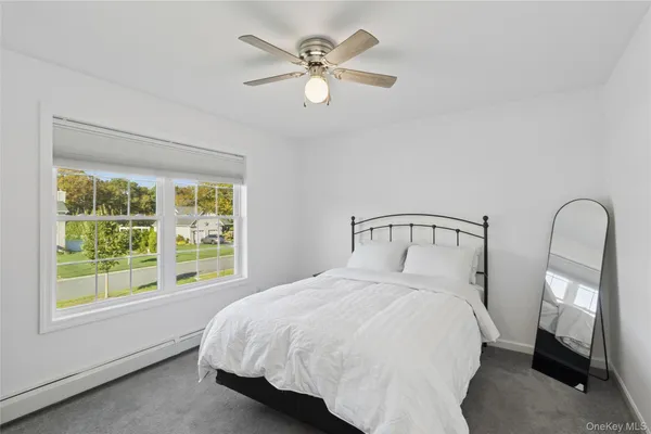 a bedroom with a large bed and a large window