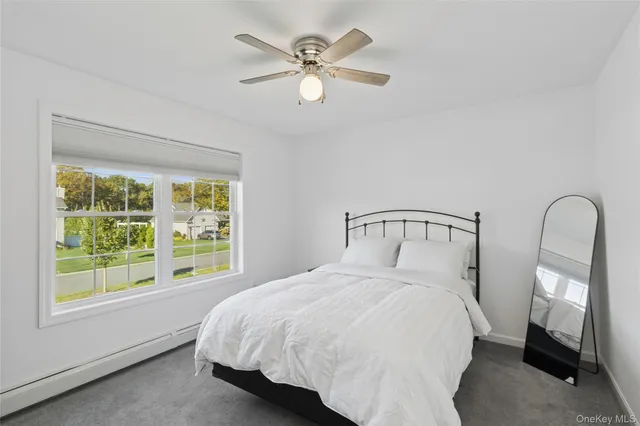 a bedroom with a large bed and a large window