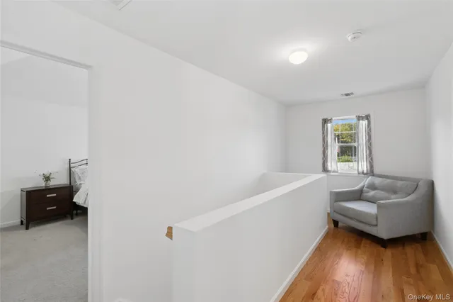 a hallway with a couch and a window