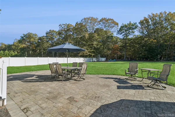 a view of a chairs and table in the yard