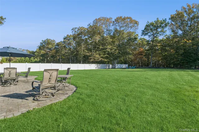 a view of a backyard with sitting area