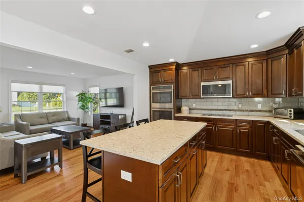 a kitchen with a table chairs refrigerator and cabinets