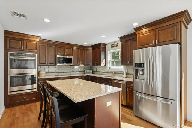 a kitchen with refrigerator cabinets and wooden floor