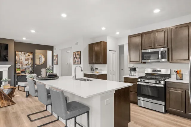 a kitchen with sink a microwave and stove