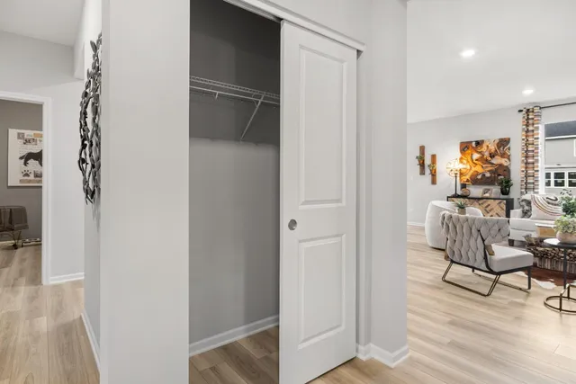 a living room with furniture and a walk in closet