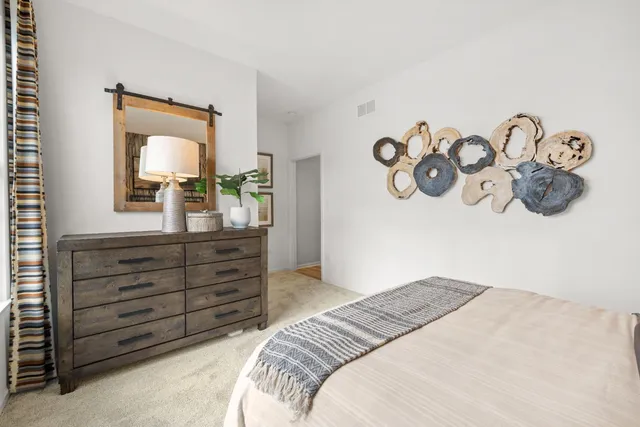 a bedroom with a bed and a dresser