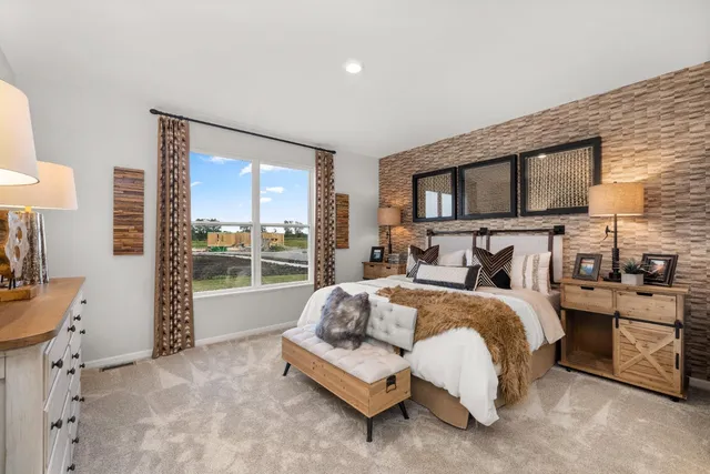 a bed sitting in a bedroom next to a window with a dresser