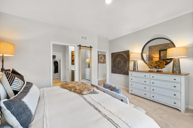 a bedroom with a bed and a dresser