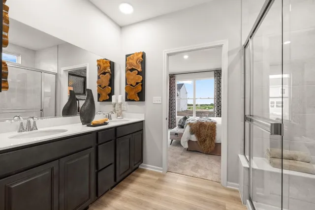 a en suite bathroom with double vanity and a shower