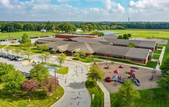 a view of a swimming pool and outdoor seating
