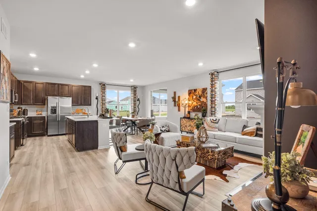 a living room with lots of furniture and kitchen view