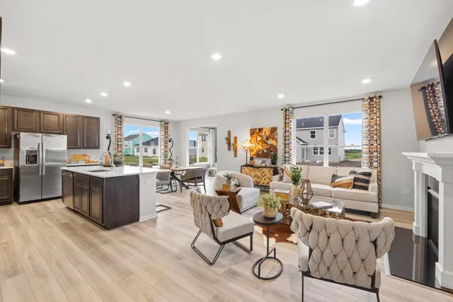 a large living room with stainless steel appliances kitchen island granite countertop a couch and a view of kitchen