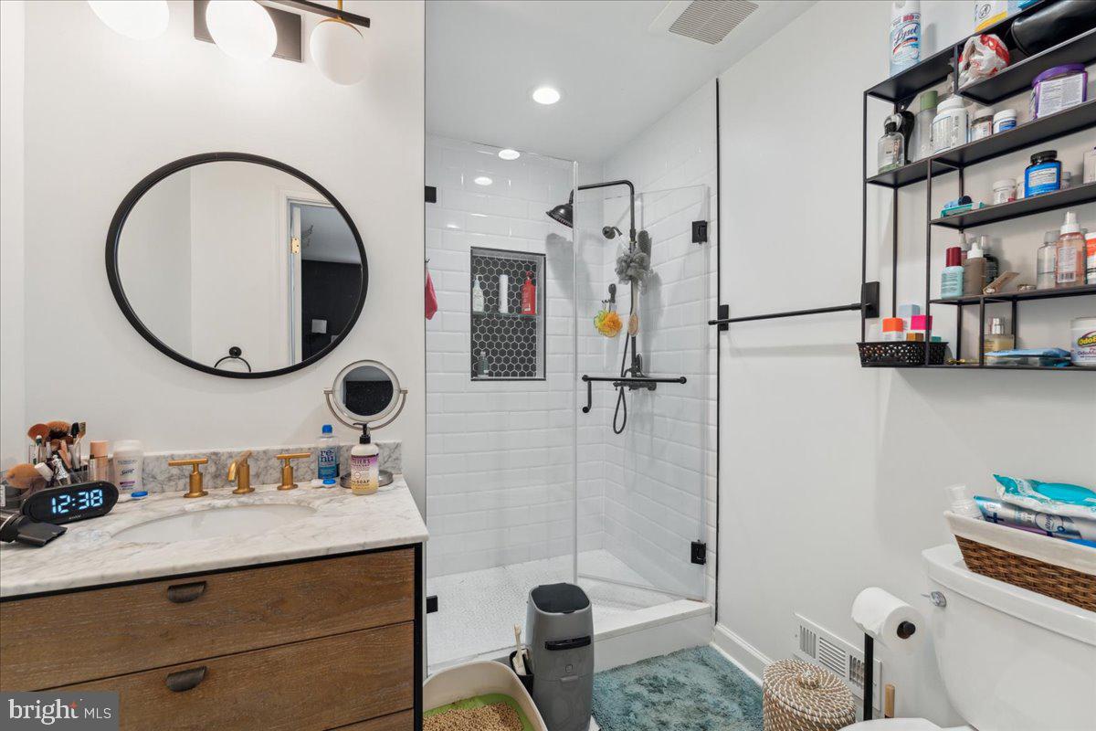 5222 Ferndale Street Springfield, VA 22151 - Photo 13 of 33 a bathroom with a sink mirror vanity and toilet